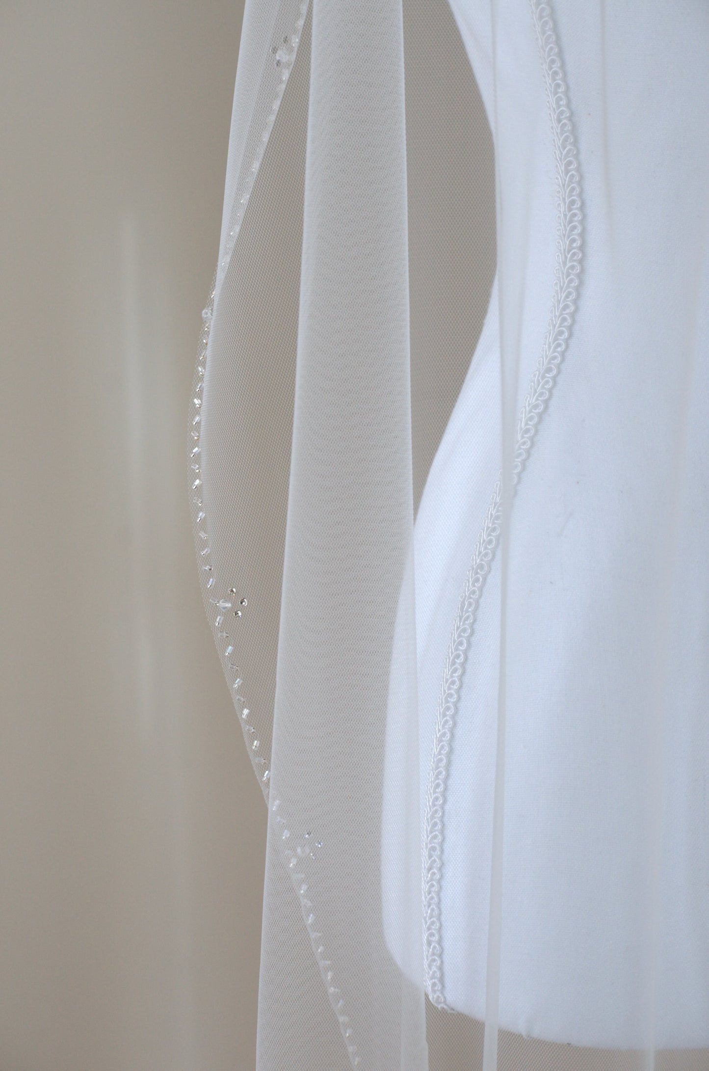 Close-up of sheer veil beaded detail onver mannequin.