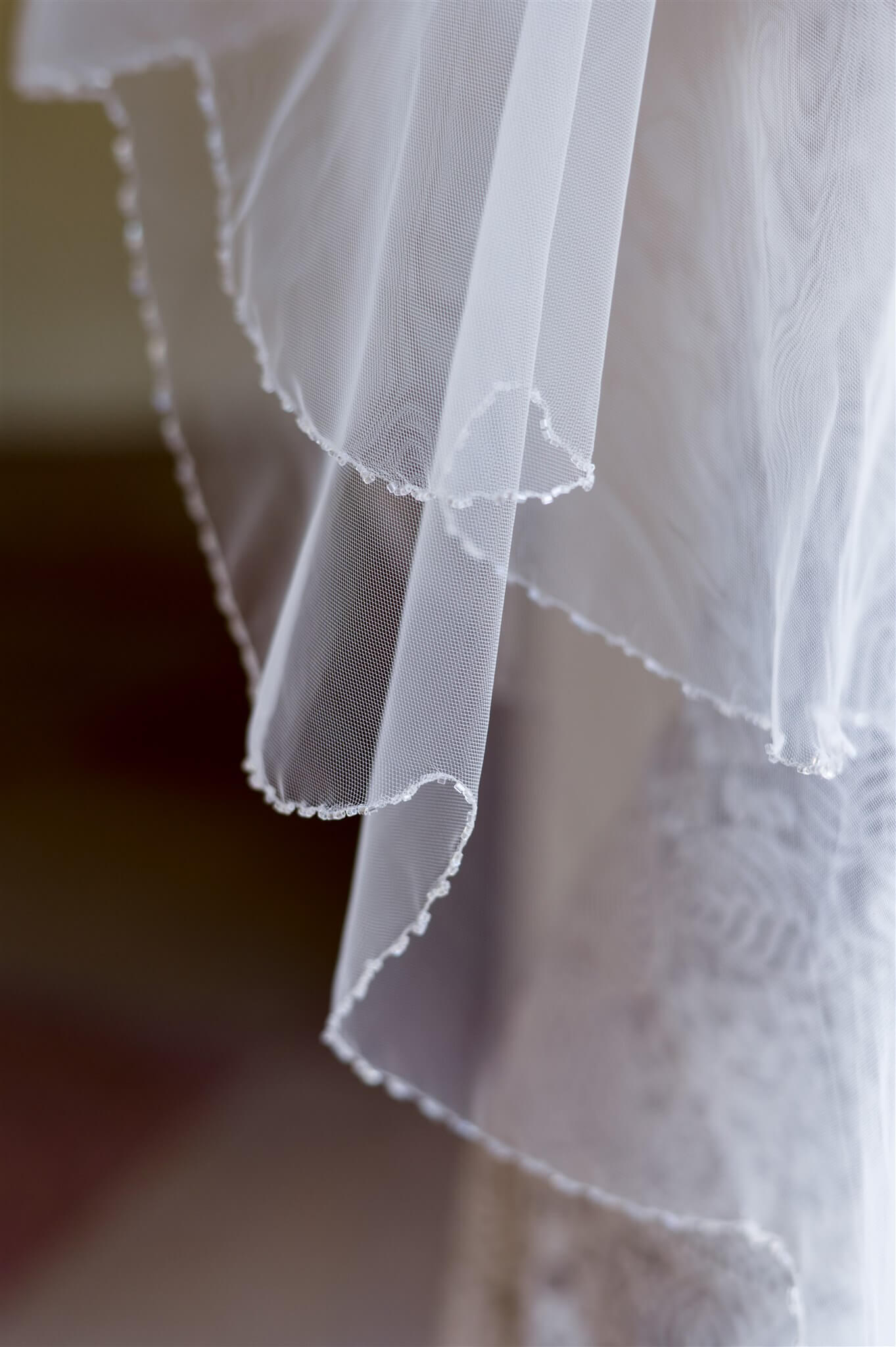 Close-up of a white lace fabric with a blurred background